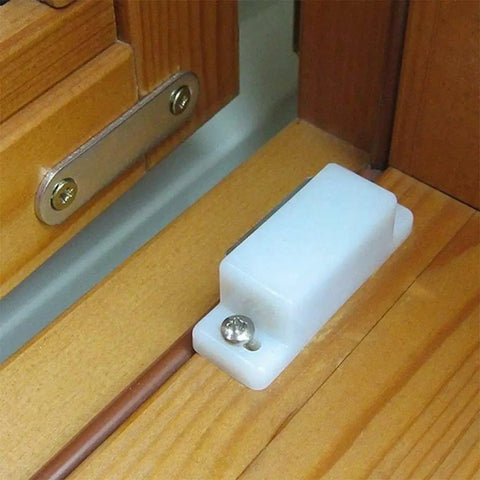 Dope Set Of 5 Magnetic Door Catches For Cabinets Wardrobes Cupboards Super Strong Hold Latches To Keep Doors Shut Tight And Look Cool Around The House. White plastic magnetic latch mounted on wooden cabinet.
