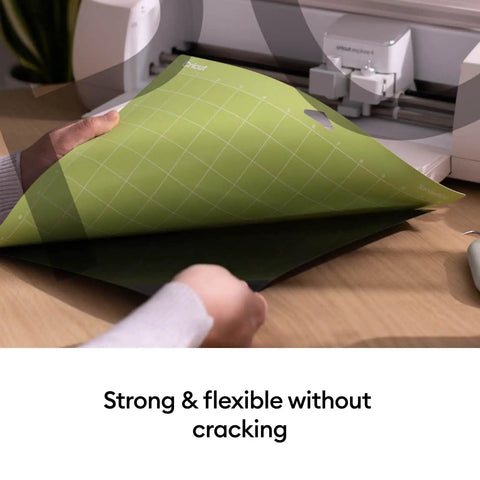 Person holding a Cutting Mat Variety Pack Four 12 By 24 Inch Mats for Crafting Workhorse Set with machine in background.