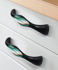 Four Pack Black Arch Cabinet Handles With Slick Marble Finish And Crystal Glass For Kitchen Drawers Bathroom Vanities And Furniture 5.6 Inch Pulls on white drawer.