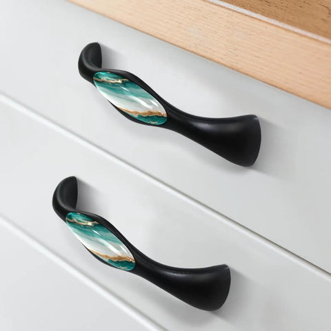 Four Pack Black Arch Cabinet Handles With Slick Marble Finish And Crystal Glass For Kitchen Drawers Bathroom Vanities And Furniture 5.6 Inch Pulls on white drawer.