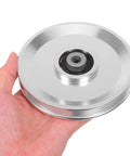 Hand holding Aluminum Alloy Fitness Pulley With Quiet Operation And Heavy Duty Bearing, 551lb Load Capacity, Beefy Gym Pulley Wheel