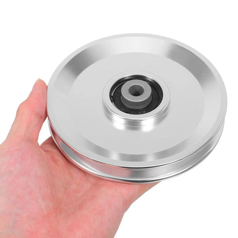 Hand holding Aluminum Alloy Fitness Pulley With Quiet Operation And Heavy Duty Bearing, 551lb Load Capacity, Beefy Gym Pulley Wheel