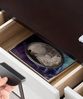 Hand holding Four Pack Half Moon Cabinet Pulls 2.5 Inch Semicircle Drawer Handle in black aluminum over open drawer