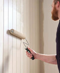 Person using American Contractor 18 Inch Paint Roller With One Half Inch Nap for smooth application on wall.