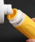 Filling shampoo into yellow On The Go Travel Bottles For Toiletries Set 5 Pack TSA Approved 3oz Leak Proof Refillable Containers
