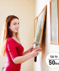 Woman using Picture Hanging Hardware Kit With Wire And Loop Sleeves For Wall Art Mirrors And Frames 91 Piece Set to hang painting