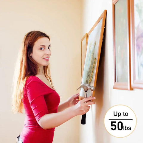 Woman using Picture Hanging Hardware Kit With Wire And Loop Sleeves For Wall Art Mirrors And Frames 91 Piece Set to hang painting