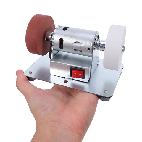 Tough Desktop Belt Sander And Badass Knife Sharpener Featuring Adjustable Grinding Angles Easy Plug-In Design Compact Motorized Finishing Machine held in hand.