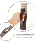 Person holding Modern Orb Finish Invisible Cabinet Drawer Pull Handle For Kitchen And Bath, 64mm Center To Center, concealed hardware.