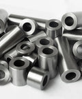 Front view of steel spacers: round, unthreaded cylindrical bushings with through-holes in silver finish.