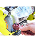 Hand using a wrench on Heavy Duty 10 Piece Wheel Dresser Replacement Blades with electric grinder for precision sharpening.