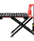 Real Deal Heavy Duty Manual High Lift Skid Jack Truck For Single Faced Pallets With Wide Poly Steer Wheels And Smooth Roll Out 2200 Lb Capacity vibrantly red with a black scissor lift base.