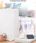 Person using Bluetooth Hygrometer Thermometer Mini Wireless Humidity Sensor with notification alerts and data storage next to humidifier.