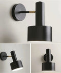 Modern Nordic Black Metal Wall Sconce Adjustable E26LED Spotlight Bedside Reading Lamp Minimalist Industrial Style Accent Lighting Fixture for Bedroom Living Room Hallway(Black) with round plate and adjustable head.