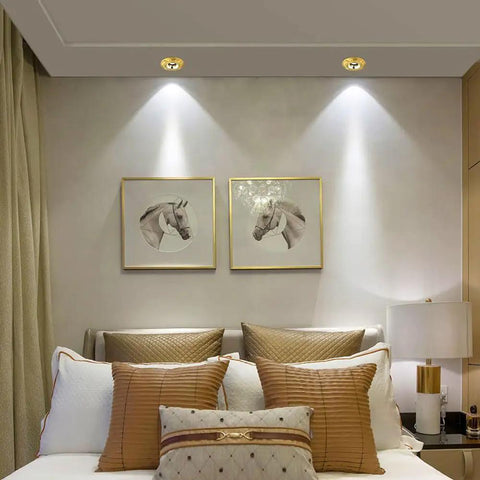 Flat Out Brilliant 4.5 Inch Recessed Led Ceiling Spotlight With Slick Brass Finish And Quick Cooling Design illuminating a stylish bedroom.