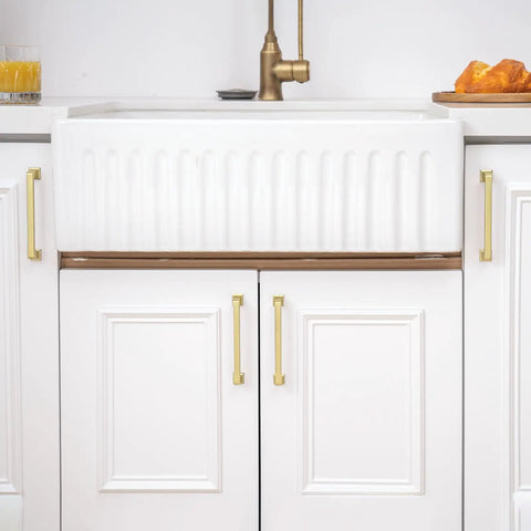 30 Pack 5 1/16 Inch Gold Cabinet Handles on white kitchen cabinets, solid zinc alloy heavy duty pulls, brushed gold finish.