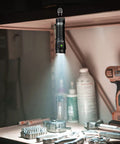 Compact EDC Rechargeable Flashlight With 1800 Lumen Output, SST 40 LED, Magnetic Tail Cap in workshop setting.