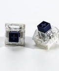 Kailh 35pcs Box Navy Clicky Mechanical Keyboard Switches, 3-Pin 95gf Pre-Lubed Heavy Force Switches For Custom Keyboards, Bold Tactile Click With Smooth Actuation Right Out Of The Box. two switch close-up, clear housing