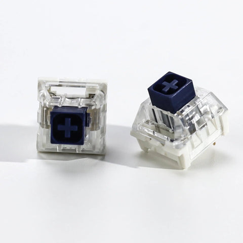 Kailh 35pcs Box Navy Clicky Mechanical Keyboard Switches, 3-Pin 95gf Pre-Lubed Heavy Force Switches For Custom Keyboards, Bold Tactile Click With Smooth Actuation Right Out Of The Box. two switch close-up, clear housing