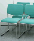 Stacked chairs on 8 Piece Rectangle Furniture Glides Self Adhesive Sliders 25mm By 100mm Floor Protectors for easy movement.
