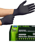 Front view of a person putting on black 6 mil nitrile disposable gloves; XXL Inspire Nitrile Gloves box visible.