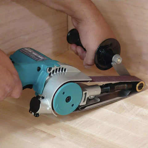Person using 1-1/8 Inch By 21 Inch Belt Sander With Narrow Belt And Exposed Front Pulley For Tight Spaces on wooden surface