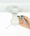 Hand attaching Ceiling Light Cover That Hides Exposed Bulbs In Seconds Clip-On Fit For Most Bulbs And Fixtures Sleek Modern