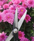 Close-up of Deluxe 8 Inch Scissors For Gardening And Crafting With Durable Carbon Steel Blades cutting pink flowers.