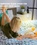 Industrial Black Floor Lamp For Living Room And Bedroom With Champagne Glass Shade illuminating a bedside scene.