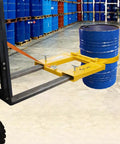 Heavy Duty Dmc Drum Grabber With 1500 Lbs Capacity Single Fork Mounted Design, lifting a 55 gallon blue drum in a warehouse.