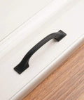 Close-up of a 3 inch solid matte black handle on drawer, from the 20 Pack 3 Inch Matte Black Kitchen Cabinet Pulls No Fuss Easy Install Solid Metal Handles For Cabinets Drawers Cupboards Kitchens Bedroom Dresser And Home Renovation Hardware Built To Last.