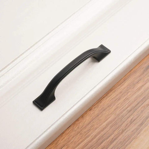 Close-up of a 3 inch solid matte black handle on drawer, from the 20 Pack 3 Inch Matte Black Kitchen Cabinet Pulls No Fuss Easy Install Solid Metal Handles For Cabinets Drawers Cupboards Kitchens Bedroom Dresser And Home Renovation Hardware Built To Last.