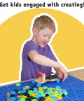 Child building with Bulk 100 Plastic Wheels And 50 Steel Axles Set For STEM Projects And DIY Cars And Crafts on a table.