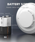 Voniko 9V alkaline battery, front view, with a smoke detector in the background