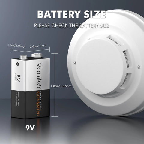 Voniko 9V alkaline battery, front view, with a smoke detector in the background