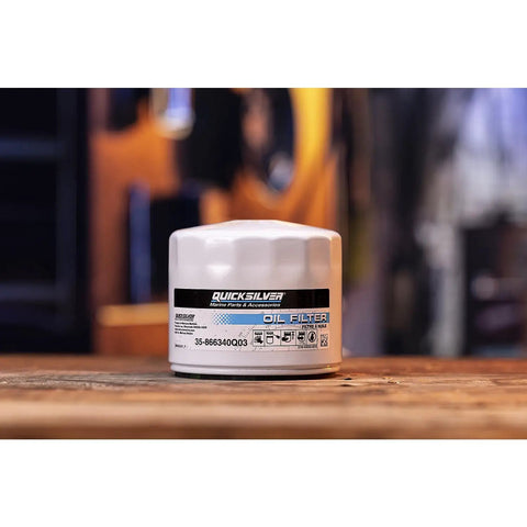Sterndrive And Inboard Spin On Oil Filter For MerCruiser And GM Marine Engines With MPleated Media And Anti Drain Back Valve Delivers Cleaner Oil And Quick Start Lubrication For High Performance Boats, placed on a wooden surface.