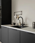 Modern kitchen with black cabinets featuring 5 Pack No Drill Adhesive Edge Finger Pulls For Cabinets And Drawers Matte Black 3.15 Inch Flat Stick On Cabinet Handles.