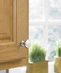 Top Notch Ten Pack Of 1.25 Inch Round Cabinet Knobs With Slick Satin Nickel Coating For Kitchen Drawers Offering A Clean Look And Rock Solid Build Quality That Really Delivers on a wooden cabinet door.