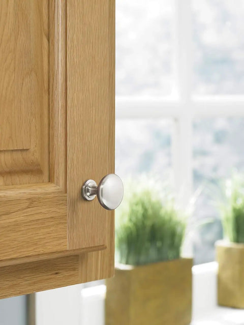 Top Notch Ten Pack Of 1.25 Inch Round Cabinet Knobs With Slick Satin Nickel Coating For Kitchen Drawers Offering A Clean Look And Rock Solid Build Quality That Really Delivers on a wooden cabinet door.