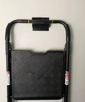 Close-up of Garage Wall Ladder Hooks 2 Pack holding a black folding ladder on a white wall, showing heavy-duty construction.