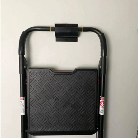 Close-up of Garage Wall Ladder Hooks 2 Pack holding a black folding ladder on a white wall, showing heavy-duty construction.