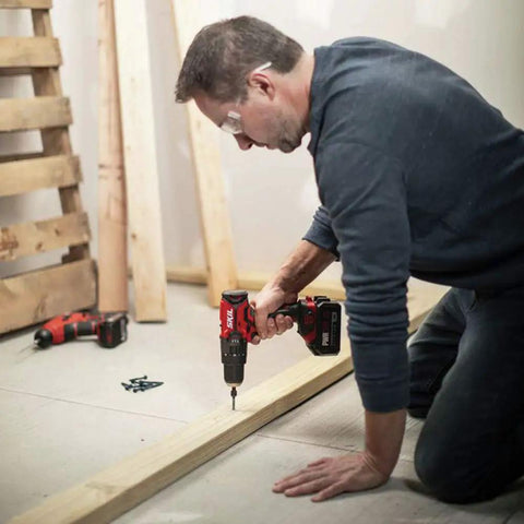 Man using PWRCore 20 Hammer Drill Kit With 2.0Ah Battery And Fast Charger for DIY home project