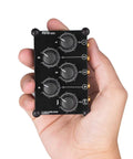 MC5 Mini Portable Stereo Mixer With Four 3.5mm Inputs And One 3.5mm Output, Passive No Power Needed Live Studio Console held in hand