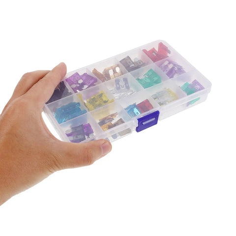 Hand holding a clear plastic box of fuses from the Automotive Fuse Kit With Tester And Puller 100 Piece Standard Tall Profile Blade Fuses Assortment Set