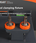 Tool clamping fixture with orange rubber holders for secure tool placement on workshop tabletop, compatible with CNC operations.