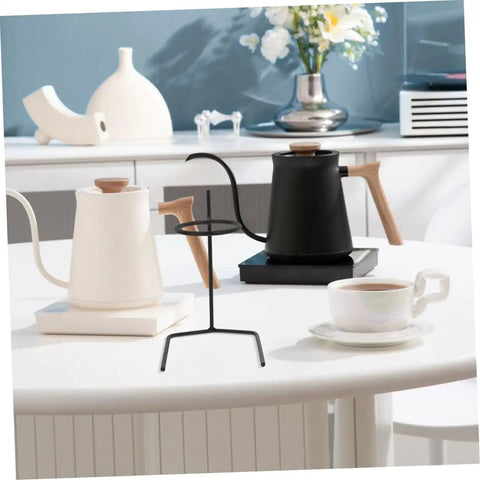 Pair Of Portable Coffee Dripper Holder And Filter Stand For Home Barista Rigs Or Weekend Warrior Campout Vibes Smooth Pour Station, black metal stand on table with kettles and cup.
