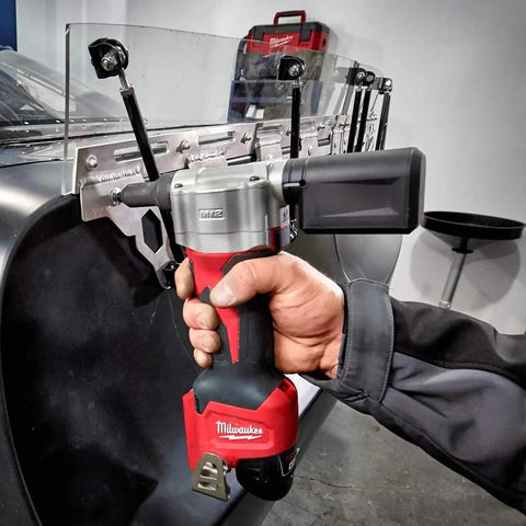 Hand using M12 Cordless Rivet Tool Kit for No Fuss Riveting on Aluminum, Steel And Stainless Rivets, 0.8 Inch Stroke, Lightweight