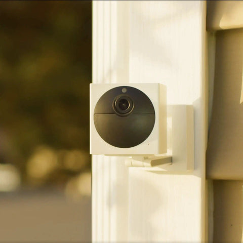 Battery Powered Wire Free Outdoor Security Camera Kit with Base Station 1080P Picture mounted on house exterior
