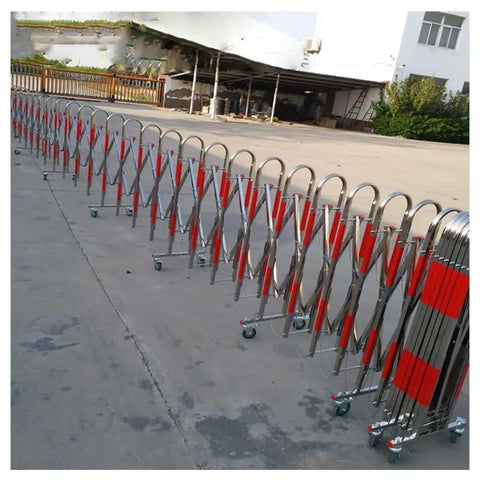 Badass Stainless Steel Retractable Fence With Smooth Rolling Casters For Crowd Control And Traffic Safety Keep Your Sites Locked Down At Malls Or Construction Zones Straight Up Reliable Expandable Barrier Gate on a pavement surface.