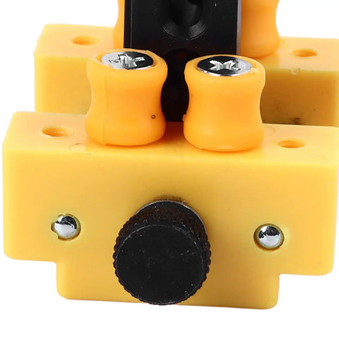 Close-up of a Mini Table Vise Clamp Drill Press Jig showing adjustment screws and yellow grips for small projects.